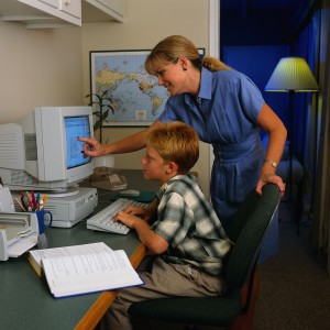 Mother Helping Son at Computer