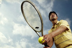 Man Serving Tennis Ball