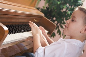 Brother and Sister Playing the Piano Together