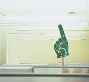 Businessman in Cubicle Raising Foam Hand